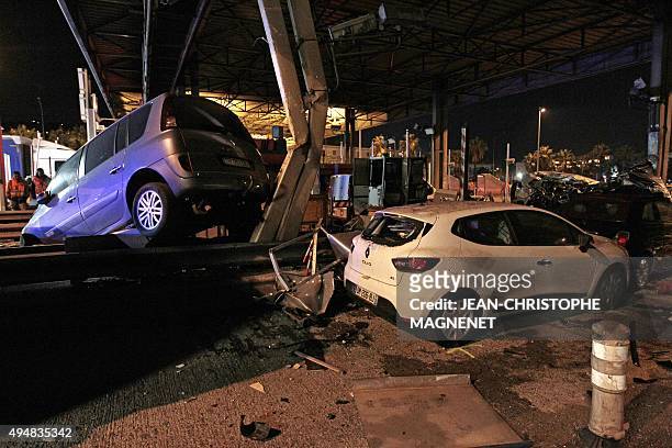 Wrecked cars are pictured after a road crash at a toll gate on the A8 highway near Nice, southeastern France, on October 29, 2015. A car transport...