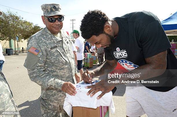 Branden Dawson of the Los Angeles Clippers participates in Feed The Community event at the Salvation Army Siemon Family Youth and Community Center in...