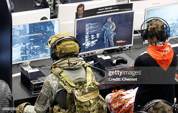 Gamers play the video game "Tom Clancy's The Division" developed by Ubisoft at Paris Games Week, a trade fair for video games on October 29, 2015 in...