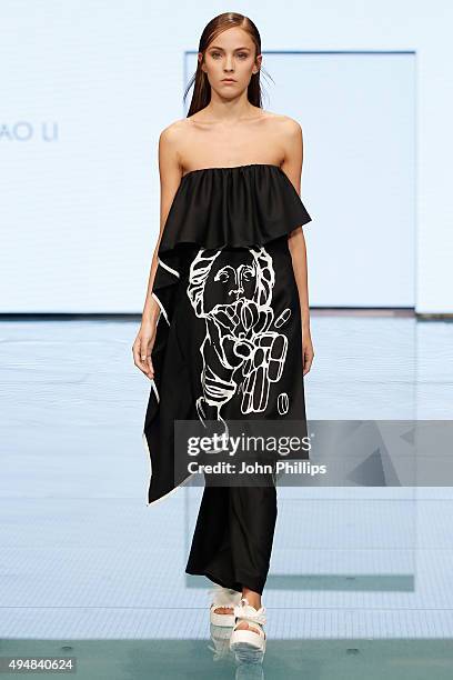 Model walks the runway at the Xiao Li show as part of the Talents Fashion show during the Vogue Fashion Dubai Experience 2015 at The Dubai Mall on...