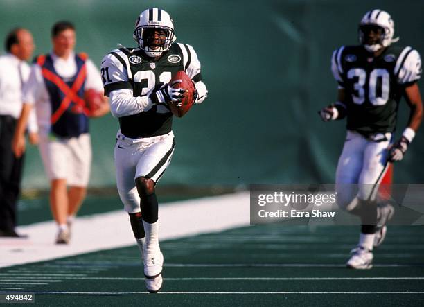 Aaron Glenn of the New York Jets runs with the ball during the game against the Washington Redskins at the Giants Stadium in East Rutherford, New...