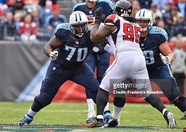 Chance Warmack of the Tennessee Titans blocks Jonathan Babineaux of the Atlanta Falcons at Nissan Stadium on October 25, 2015 in Nashville, Tennessee.