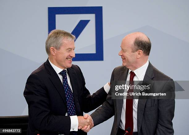 John Cryan and Juergen Fitschen CEO's of Deutsche Bank AG , during the press conference in Frankfurt. In the background the German Bank Logo.