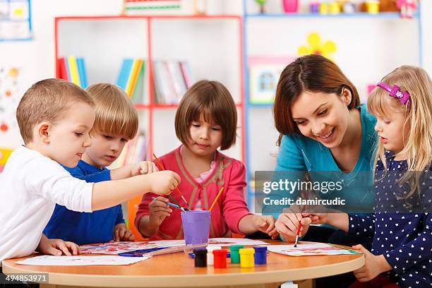 group of elementary age children in art class with teacher - school boy art stock pictures, royalty-free photos & images