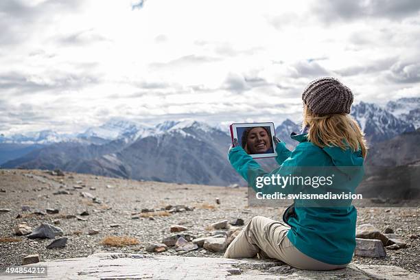 young woman at mountain top using digital tablet - 360 tablet stock pictures, royalty-free photos & images