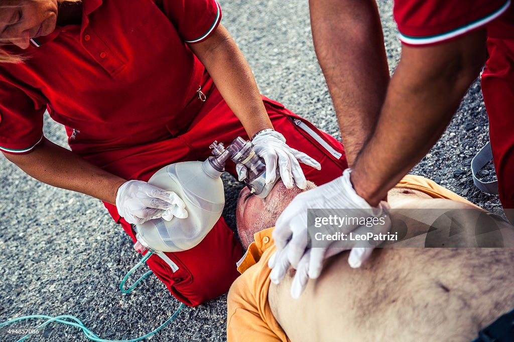 EMT team provide first aid on the street