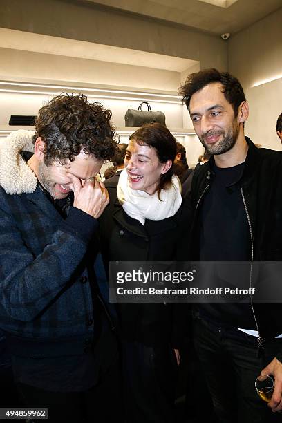 Star Dancer Marie Agnes Gillot standing between Members of Musical Group Aaron, Simon Buret and Olivier Coursier attend the Opening of the Collection...