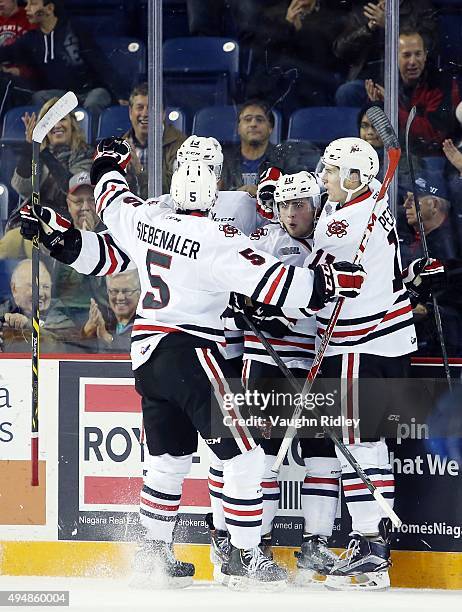 Anthony DiFruscia of the Niagara IceDogs celebrates a goal with teammates during an OHL game against the Mississauga Steelheads at the Meridian...