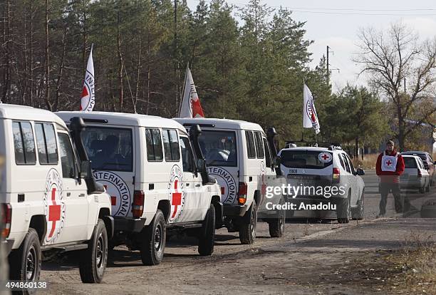 Red Cross supervision team is seen during an exchange of prisoners near Schastie village in Luhansk, eastern Ukraine, Thursday, Oct. 29, 2015. Nine...