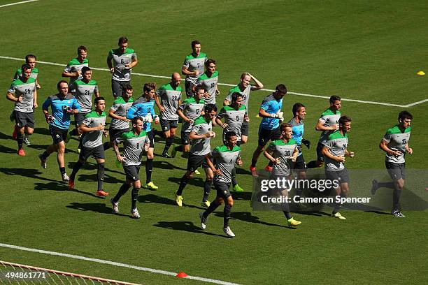 The Socceroos warm up in front of the public during a FIFA Open Day Australian Socceroos training session at Arena Unimed Sicoob on May 31, 2014 in...