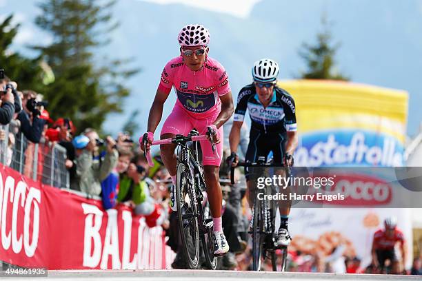 Nairo Quintana of Colombia and team Movistar crosses the finish line ahead of Rigoberto Uran of Colombia and team Omega Pharma-QuickStep at the end...