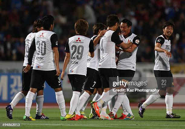 Daisuke Nasu of Urawa Red Diamonds celebrates scoring his team's first goal with his teammates during the J.League Yamazaki Nabisco Cup Group B match...
