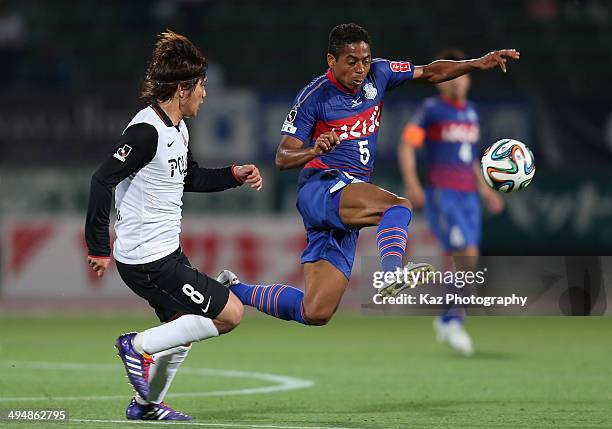 Marquinhos Parana, whose real name is Antonio Marcos da Silva Filho of Ventforet Kofu and Yosuke Kashiwagi of Urawa Red Diamonds compete for the ball...