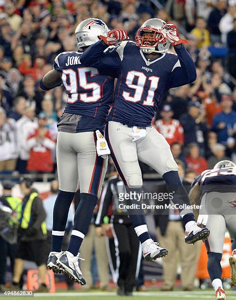 Chandler Jones and Jamie Collins of the New England Patriots react during the second quarter against the Miami Dolphins at Gillette Stadium on...