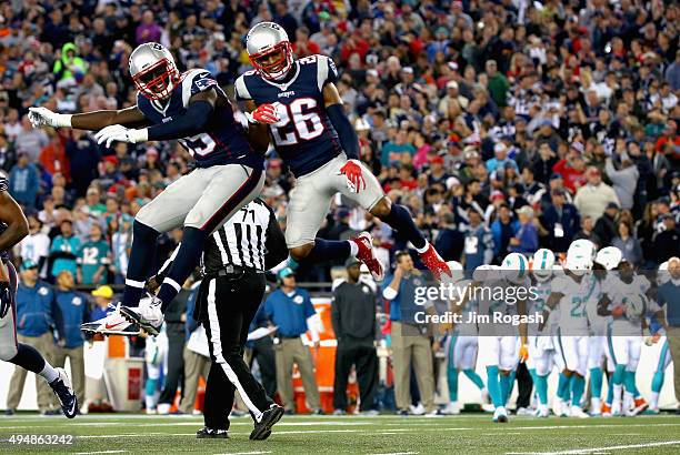 Logan Ryan of the New England Patriots reacts with Michael Williams after intercepting a pass during the second quarter against the Miami Dolphins at...