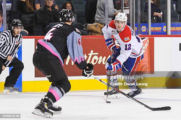 Micheal Zipp of the Calgary Hitmen defends against Markson Bechtold of the Spokane Chiefs during a WHL game at Scotiabank Saddledome on October 29,...