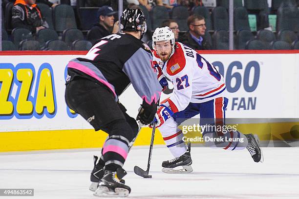 Micheal Zipp of the Calgary Hitmen defends against Kolten Olynek of the Spokane Chiefs during a WHL game at Scotiabank Saddledome on October 29, 2015...