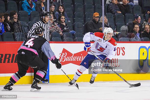 Micheal Zipp of the Calgary Hitmen defends against Adam Helewka of the Spokane Chiefs during a WHL game at Scotiabank Saddledome on October 29, 2015...