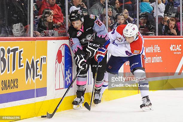 Connor Rankin of the Calgary Hitmen battles for the puck against Nik Andersen of the Spokane Chiefs during a WHL game at Scotiabank Saddledome on...