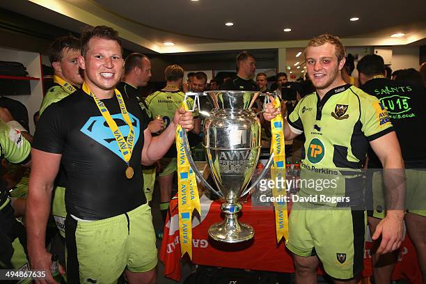 Dylan Hartley and Mike Haywood of Northampton Saints pose with the Aviva trophy in the dressing room during the Aviva Premiership Final between...