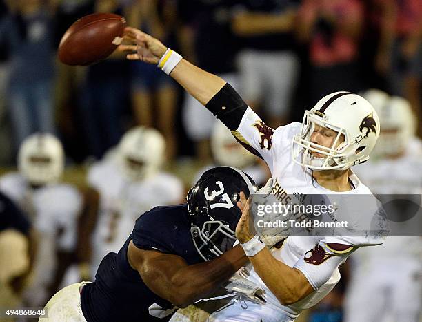 Quarterback Tyler Jones of the Texas State Bobcats is hit by linebacker Antwione Williams of the Georgia Southern Eagles during the fourth quarter on...