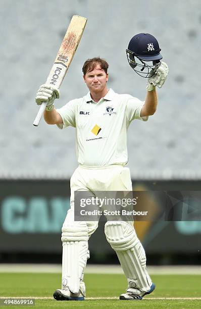 Travis Dean of Victoria celebrates as he reaches his century during day three of the Sheffield Shield match between Victoria and Queensland at...