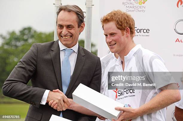 Andre Konsbruck, Director of Audi UK, and Prince Harry attend day one of the Audi Polo Challenge at Coworth Park Polo Club on May 31, 2014 in Ascot,...