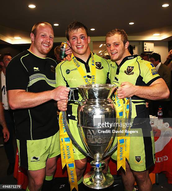 Ross McMillan, Alex Waller and Mike Haywood of Northampton Saints celebrate with the trophy following victory in the Aviva Premiership Final between...