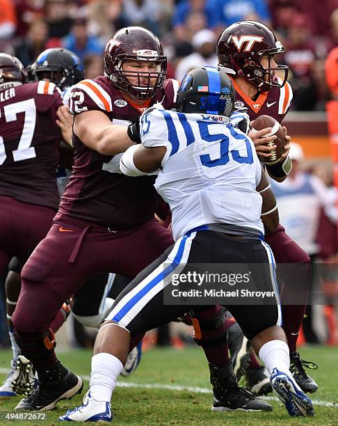 Offensive lineman Augie Conte of the Virginia Tech Hokies blocks defensive tackle Brandon Boyce of the Duke Blue Devils in the first half at Lane...