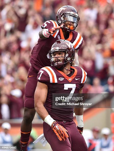 Tight end Bucky Hodges of the Virginia Tech Hokies celebrates his touchdown reception with wide receiver Cam Phillips in the first half against the...