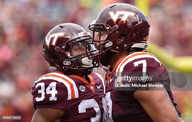 Tight end Bucky Hodges of the Virginia Tech Hokies celebrates his touchdown reception with running back Travon McMillian in the first half against...