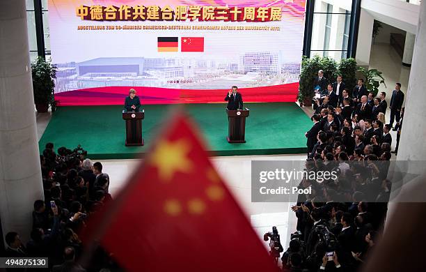 German Chancellor Angela Merkel and Chinese Premier Li Keqiang hold a speech during their visit of the German University on October 30, 2015 in...