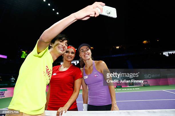 Sania Mirza of India and Martina Hingis of Switzerland take a selfie with a fan after defeating Timea Babos of Hungary and Kristina Mladenovic of...