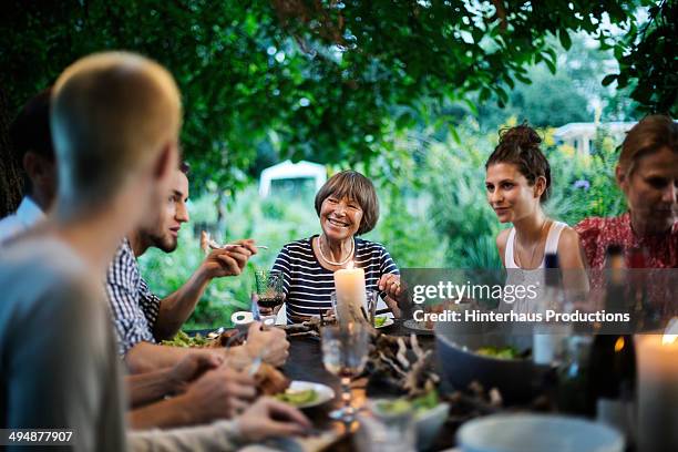 family having a garden party - eating together stock pictures, royalty-free photos & images