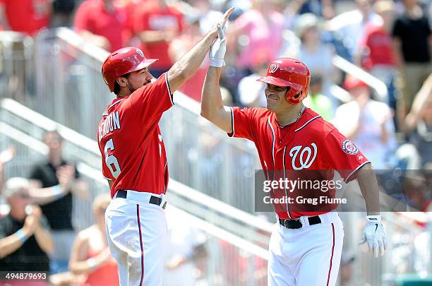 Scott Hairston of the Washington Nationals celebrates with Anthony Rendon after hitting a home run in the sixth inning against the Texas Rangers at...