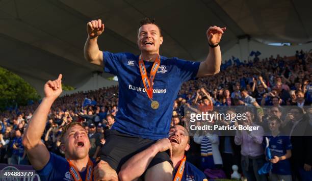 Brian O'Driscoll of Leinster, celebrates at the end of the last match of his career, carried by Ian Madigan and Cian Healy after winning the Pro 12...