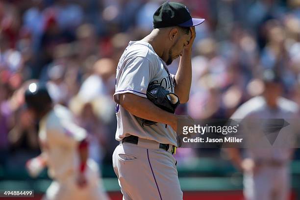 Starting pitcher Franklin Morales of the Colorado Rockies reacts as Mike Aviles of the Cleveland Indians rounds the bases after hitting a three-run...