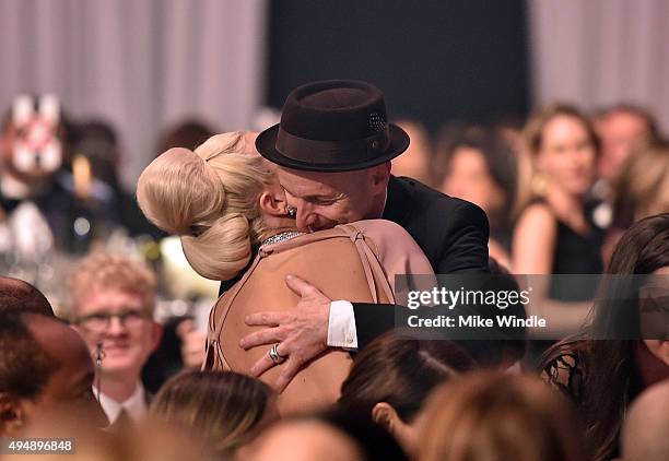 Recording artist/actress Lady Gaga and actor Denis O'Hare embrace at amfAR's Inspiration Gala Los Angeles at Milk Studios on October 29, 2015 in...