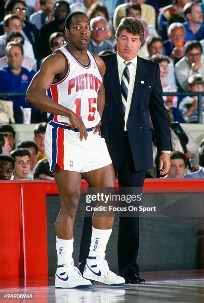 Vinnie Johnson of the Detroit Pistons looks on with head coach Chuck Daly against the Boston Celtics during an NBA basketball game circa 1987 at the...