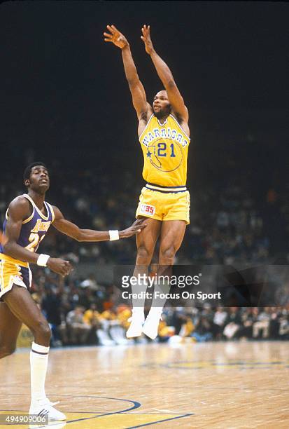 World B. Free of the Golden State Warriors shoots over Michael Cooper of the Los Angeles Lakers during an NBA basketball game circa 1980 at the...