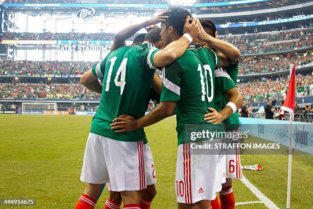 Giovani dos Santos celebrates with his team mates after scoring the third goal of the match during the International Friendly match between Mexico...