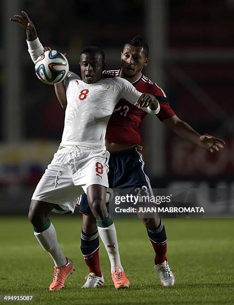 Senegal's midfielder Dame Diop vies for the ball with Colombia's defender Carlos Valdes during a friendly football match at Pedro Bidegain stadium in...