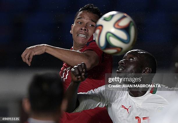 Colombia's forward Carlos Bacca heads the ball next to Senegal's defender Ibrahima Khaliloulah Seck during a friendly football match at Pedro...
