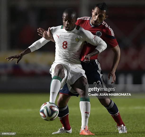 Senegal's midfielder Dame Diop vies for the ball with Colombia's defender Carlos Valdes during a friendly football match at Pedro Bidegain stadium in...