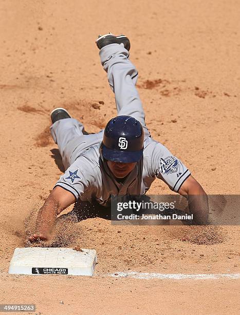 Will Veeable of the San Diego Padres dives safely back to first base in the 8th inning against the Chicago White Sox at U.S. Cellular Field on May...