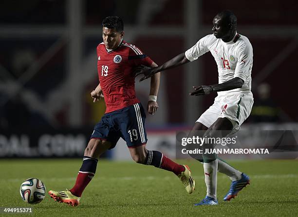 Colombia's forward Teofilo Gutierrez vies for the ball with Senegal's defender Ibrahima Khaliloulah Seck during a friendly football match at Pedro...