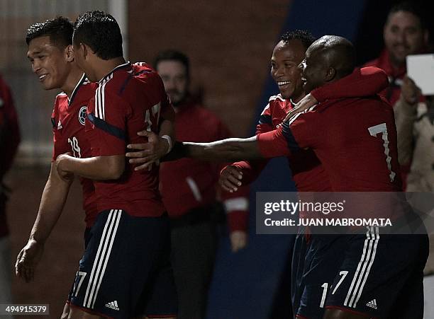 Colombia's forward Teofilo Gutierrez celebrates next to teammates forward Carlos Bacca defender Camilo Zuniga and defender Pablo Armero after scoring...