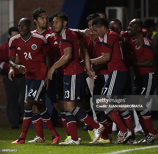 Colombia's forward Teofilo Gutierrez celebrates with teammates after scoring against Senegal during a friendly football match at Pedro Bidegain...