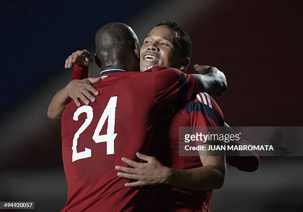 Colombia's forward Carlos Bacca celebrates with teammate midfielder Victor Ibarbo after scoring the team's second goal against Senegal at Pedro...