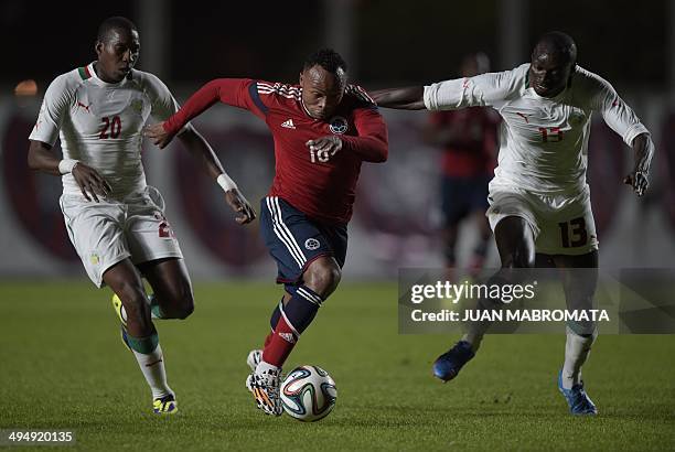 Colombia's defender Camilo Zuniga vies for the ball with Senegal's defender Ibrahima Khaliloulah Seck and midfielder Mohamed El Habib Daf during a...